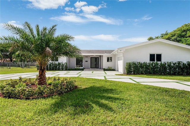 ranch-style house with a front lawn and a garage