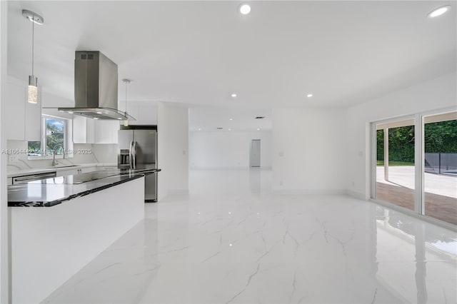 kitchen featuring stainless steel appliances, white cabinetry, dark countertops, island exhaust hood, and pendant lighting