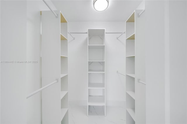 spacious closet with marble finish floor