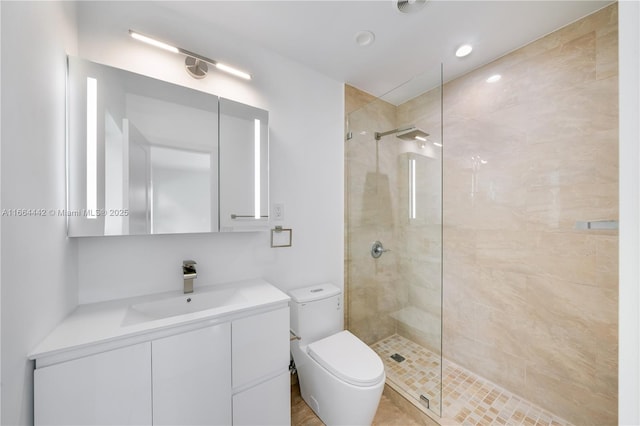 bathroom featuring vanity, toilet, and a walk in shower