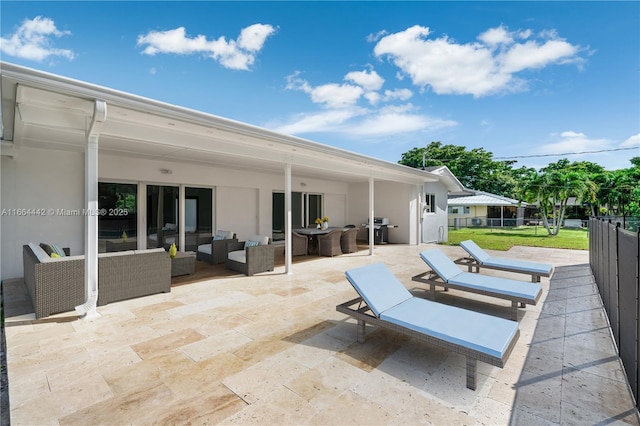 view of patio / terrace with fence, an outdoor living space, and area for grilling