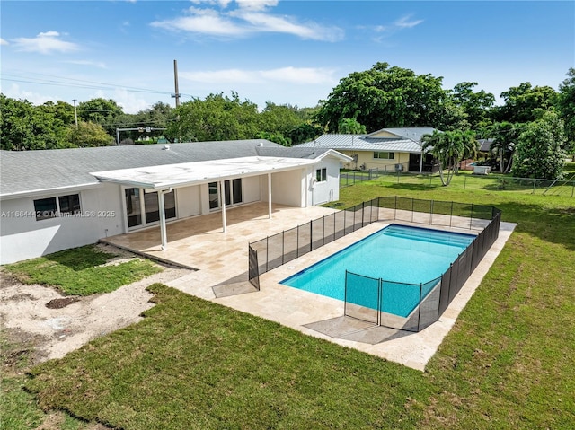 view of swimming pool with a yard, a patio area, fence, and a fenced in pool