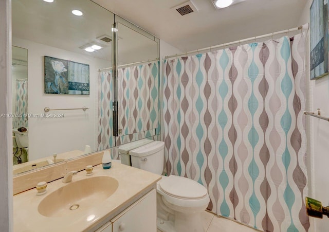 bathroom with vanity, tile patterned flooring, toilet, and tile walls