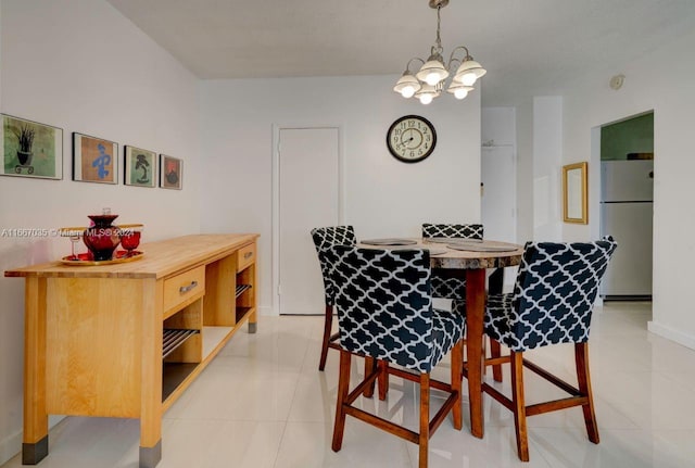 dining space with light tile patterned floors and a chandelier