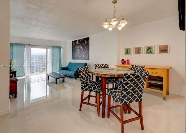 tiled dining space with a notable chandelier and a textured ceiling