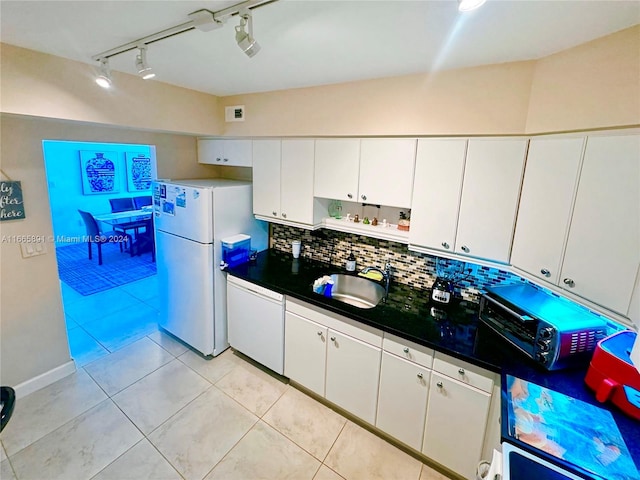 kitchen with light tile patterned flooring, sink, white appliances, track lighting, and white cabinetry