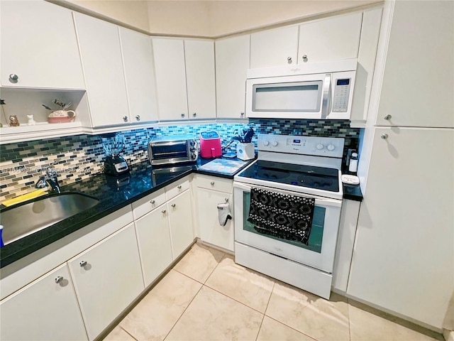 kitchen with backsplash, white appliances, sink, and white cabinets