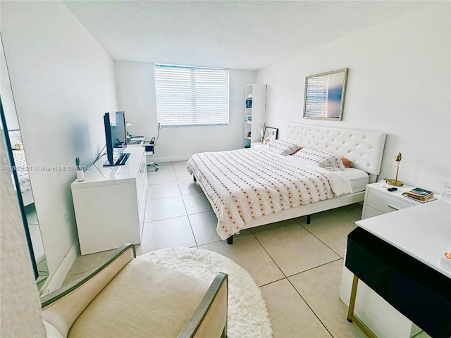 tiled bedroom with a textured ceiling