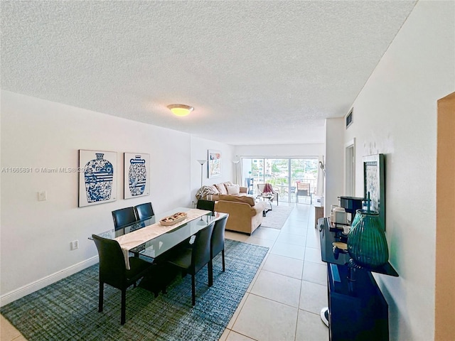 500 Bayview Dr Unit 325, Sunny Isles Beach, FL 33160 - tiled dining area featuring a textured ceiling