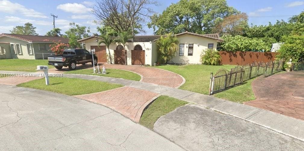 view of front facade with a garage and a front lawn