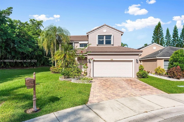 mediterranean / spanish home with a front lawn and a garage