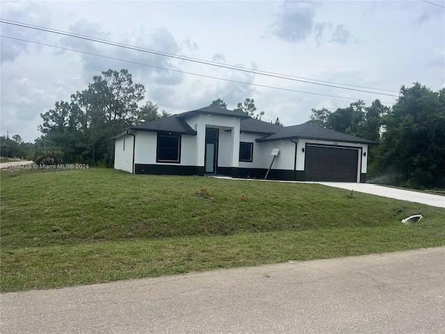 view of front facade with a front yard and a garage