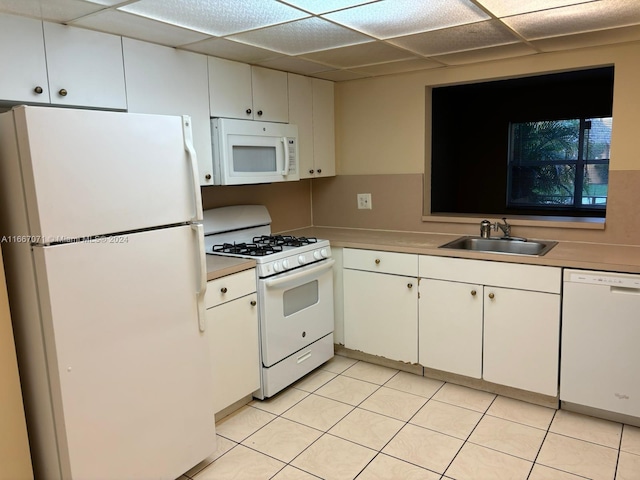 kitchen with white cabinets, sink, and white appliances