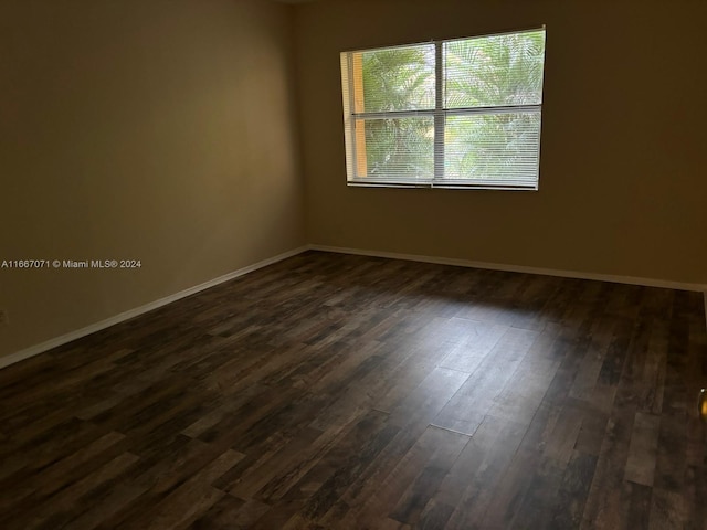 spare room with dark hardwood / wood-style floors