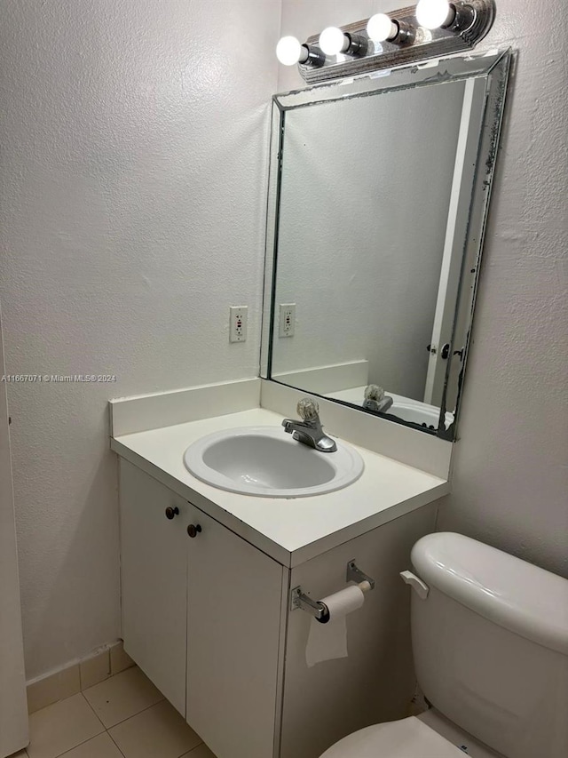 bathroom featuring tile patterned flooring, vanity, and toilet