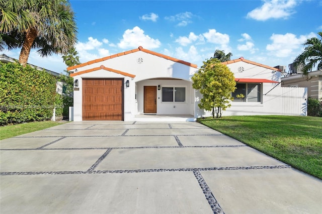 view of front of house with a garage and a front lawn