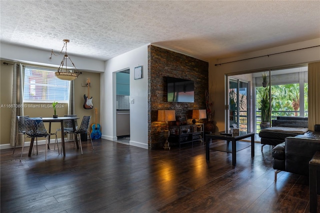 living room featuring a textured ceiling and dark wood-type flooring