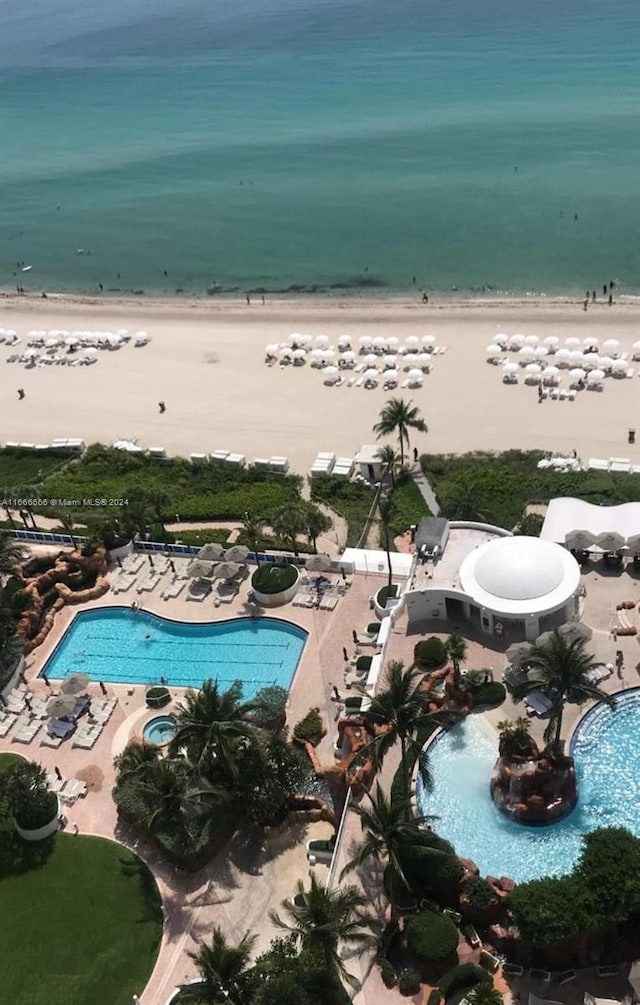 aerial view featuring a view of the beach and a water view