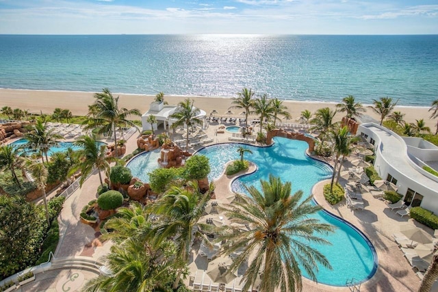 aerial view with a water view and a beach view