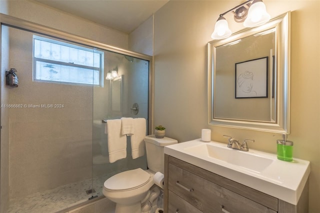 bathroom featuring an enclosed shower, vanity, and toilet