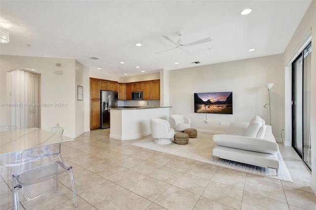 living room featuring ceiling fan and light tile patterned flooring