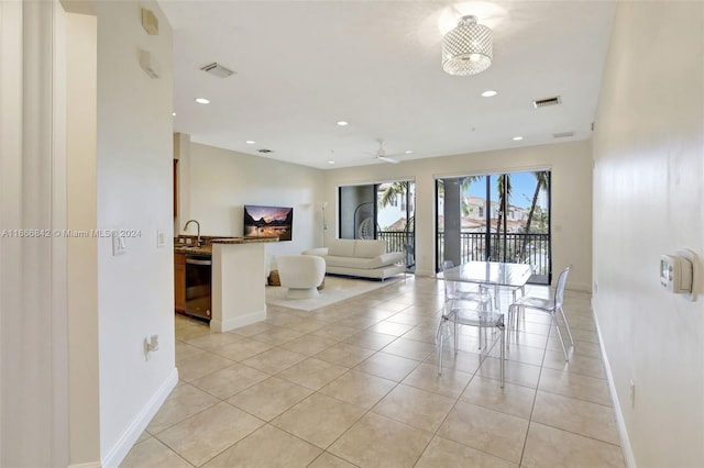 tiled empty room with ceiling fan and sink