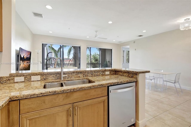 kitchen with dishwasher, sink, light tile patterned floors, light stone countertops, and ceiling fan