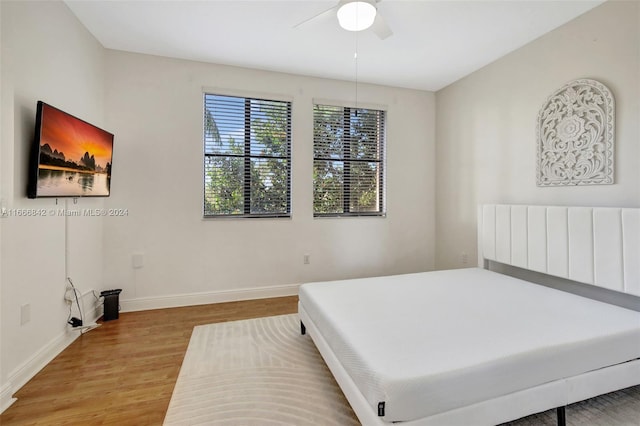 bedroom with hardwood / wood-style floors and ceiling fan