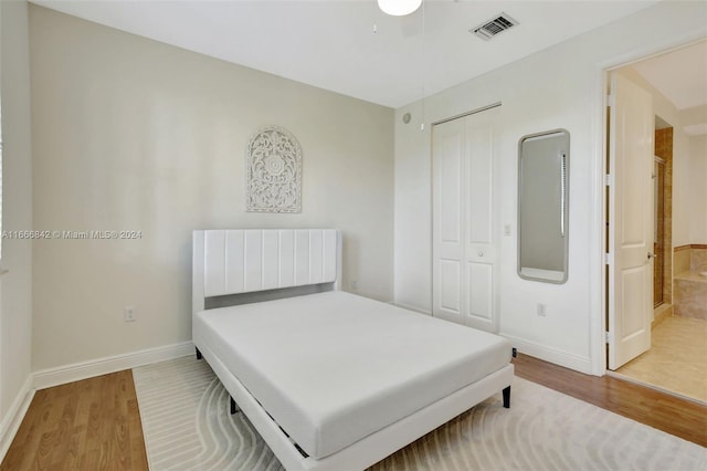 bedroom with a closet and hardwood / wood-style flooring