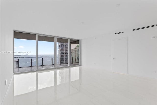 unfurnished room featuring expansive windows