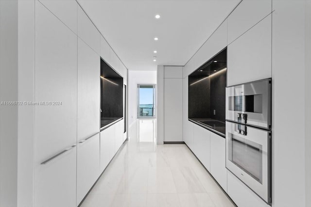 kitchen with double oven and white cabinets