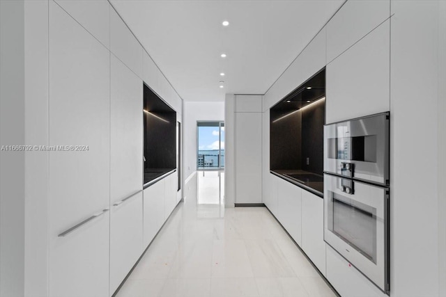 kitchen featuring white cabinetry and stainless steel double oven