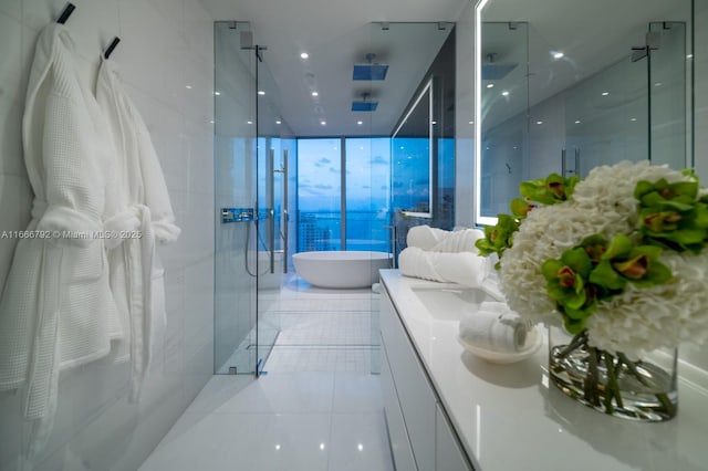 300 Biscayne Blvd Way Unit 3403, Miami, FL 33131 - bathroom featuring a stall shower, a freestanding tub, vanity, floor to ceiling windows, and tile patterned floors