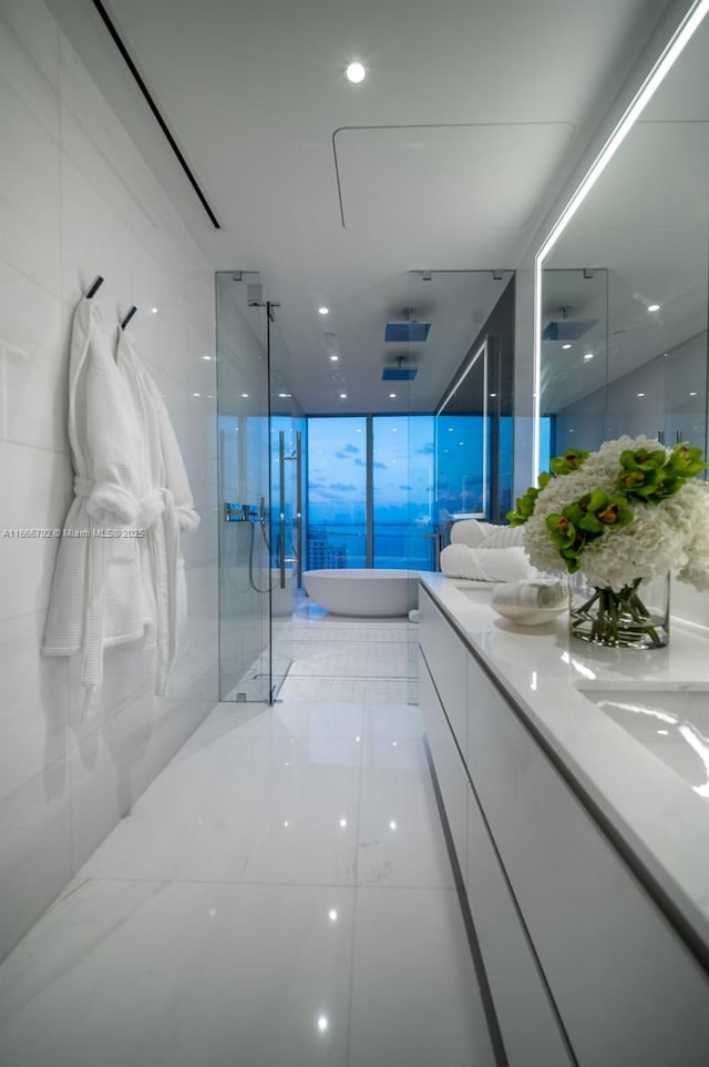 300 Biscayne Blvd Way Unit 3403, Miami, FL 33131 - full bath featuring a walk in shower, double vanity, a soaking tub, a wall of windows, and tile patterned floors