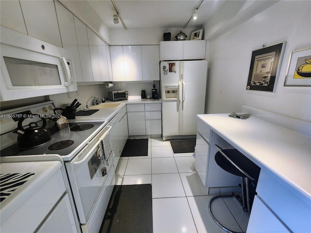 kitchen featuring light tile patterned flooring, white cabinets, white appliances, track lighting, and sink