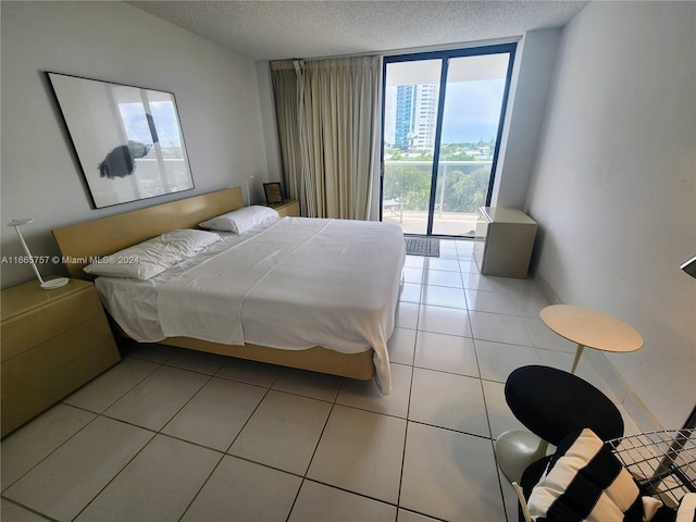 tiled bedroom with a textured ceiling and access to exterior