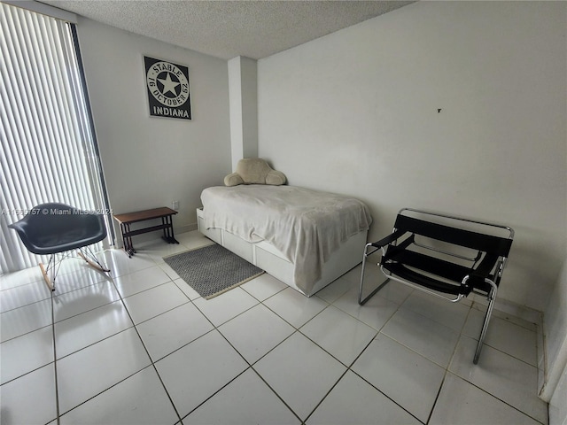 tiled bedroom featuring a textured ceiling