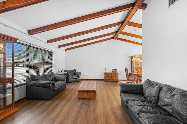 living room featuring lofted ceiling with beams and wood-type flooring