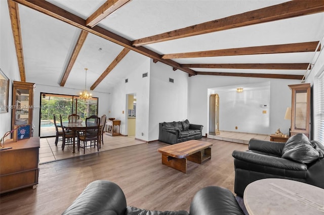 living room with a notable chandelier, vaulted ceiling with beams, and hardwood / wood-style flooring