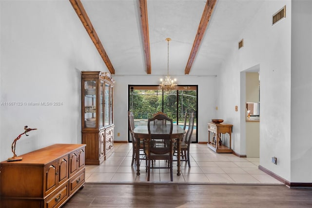 dining room with light wood-type flooring, vaulted ceiling with beams, and a chandelier