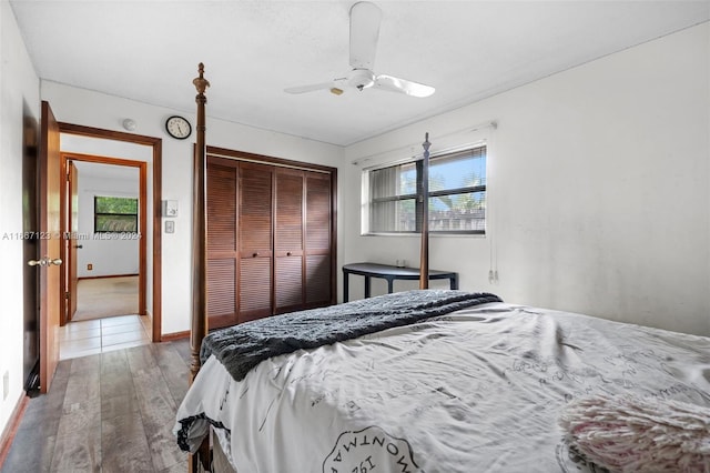 bedroom featuring multiple windows, ceiling fan, a closet, and hardwood / wood-style flooring