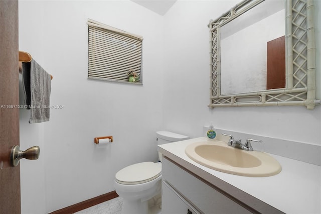 bathroom featuring tile patterned flooring, vanity, and toilet