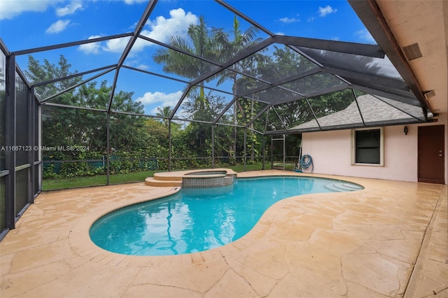 view of pool featuring glass enclosure, an in ground hot tub, and a patio area