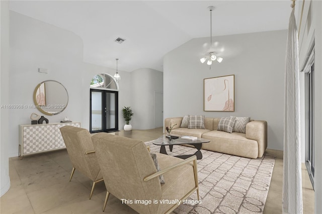 living room featuring vaulted ceiling and a notable chandelier