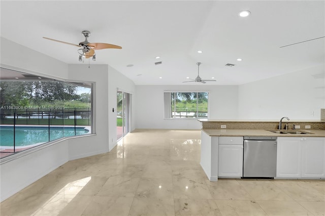 kitchen with dishwasher, white cabinetry, plenty of natural light, and sink