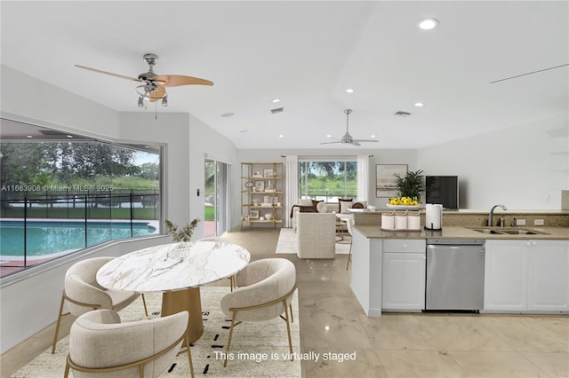 kitchen with ceiling fan, dishwasher, white cabinets, and sink