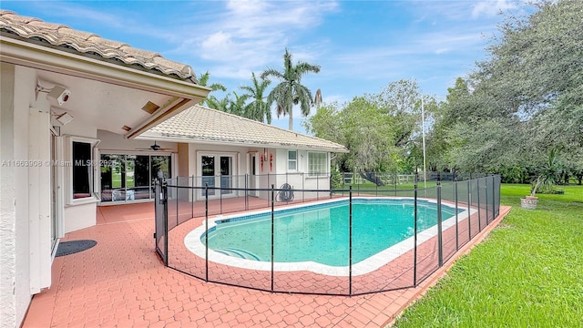 view of swimming pool with a lawn, ceiling fan, and a patio