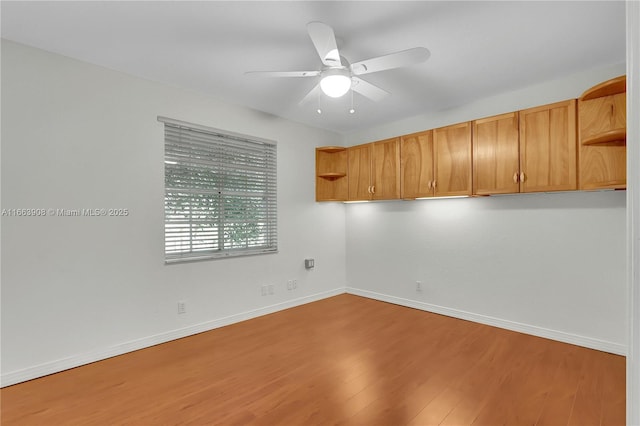 unfurnished room with hardwood / wood-style flooring and ceiling fan