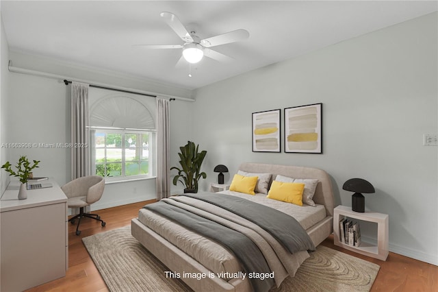 bedroom with ceiling fan and light hardwood / wood-style flooring