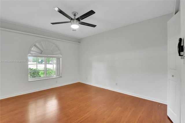 empty room with ceiling fan and hardwood / wood-style floors